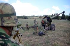 Army training with towed gun howitzers