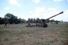 Army training with towed gun howitzers