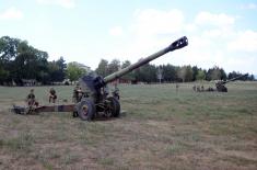 Army training with towed gun howitzers