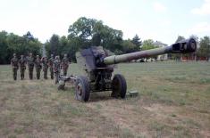 Army training with towed gun howitzers