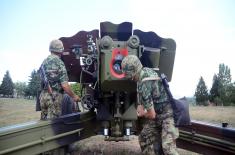 Army training with towed gun howitzers