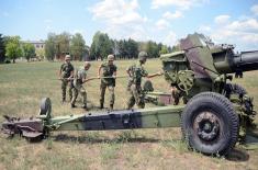 Army training with towed gun howitzers