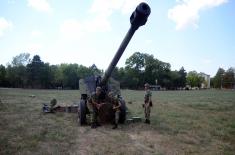 Army training with towed gun howitzers