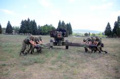 Army training with towed gun howitzers