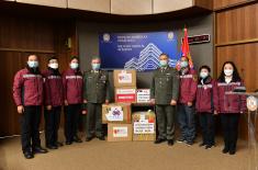A donation of the Chinese medical team members to the Military Healthcare Department