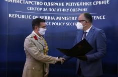 Assistant Minister Ranković presents the UK Defence Attaché, Colonel Ilić, with a certificate of appreciation