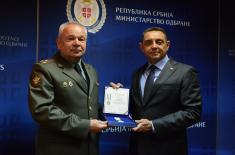 Minister Vulin presents the Russian Defence Attaché, Colonel Sobakin, with a Military Memorial Medal