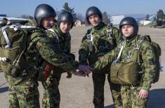 Soldiers performing military service make their first parachute jumps