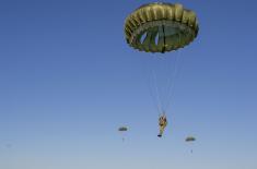 Soldiers performing military service make their first parachute jumps