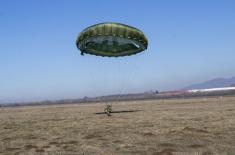 Soldiers performing military service make their first parachute jumps