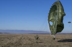 Soldiers performing military service make their first parachute jumps